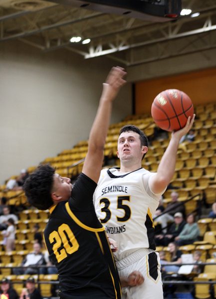 Power shot--
Senior forward Brett Boyles goes in for a lay up during the 49-25  season opening win over  Snyder on Nov. 12. Boyles is one of two returning varsity players who opened the season without those in football play offs.