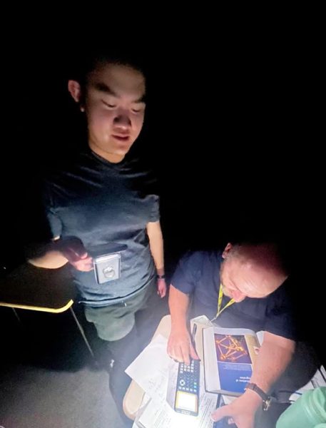 Still working--
Senior Jack Chen holds the light as UIL math Coach Anthony Newberry works a problem during afternoon practice on Jan. 31. Chen posted, “The power is out, and we’re still doing math.”