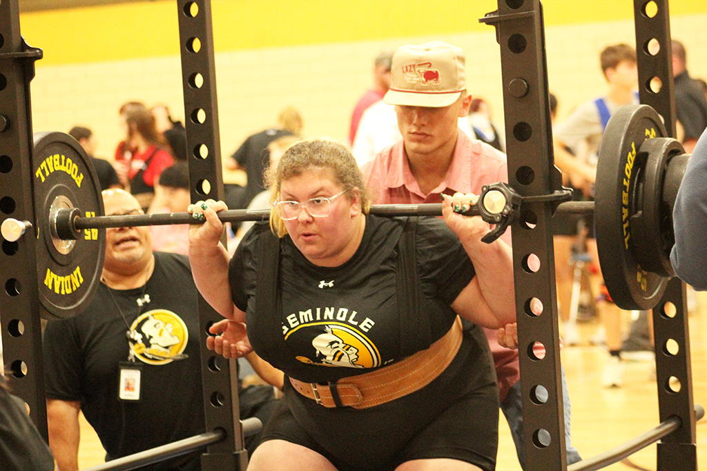 Focus--Sophomore Mikayla Bush squats at the home meet on Jan. 16. Bush squatted 250 pounds on her way to a second place finish.