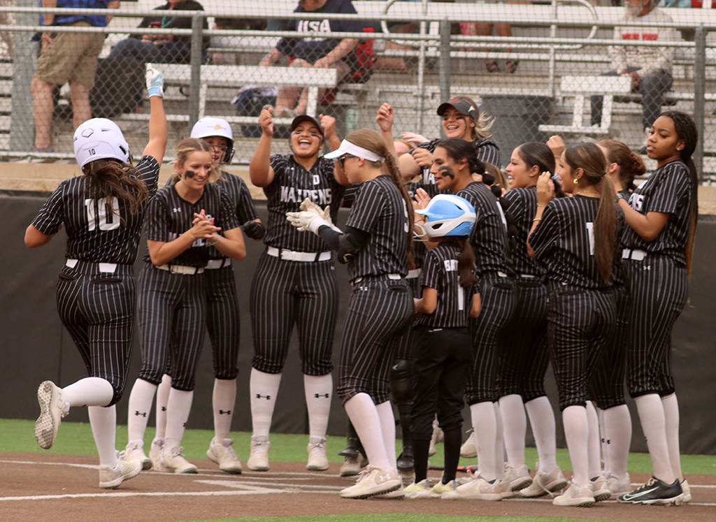 Final celebration--Maidens cheer as first baseman junior Monica Morin gets a homerun to win the game on March 18. The Maidens defeated Greenwood in district play, 20-10, in five innings.