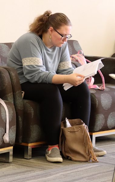 Prepped to win--Junior Serena Wiebe reads over literary terms before competing in literary criticism on March 1 at the Texas Tech "March Madness" UIL meet. Wiebe took first, and her team which included sophomore Anaiah Beydoun and junior Tristan Goodwin, took first overall as well.