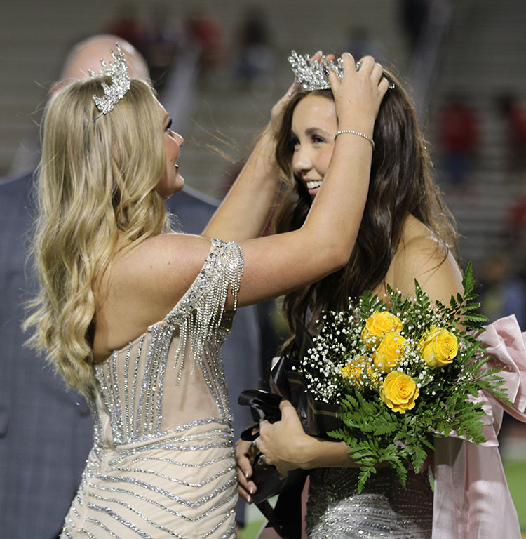 Crowning moment--2025 homecoming Queen Olivia Hicks sets the crown on  2026 Queen Xyla Guenther during halftime on Sept. 12