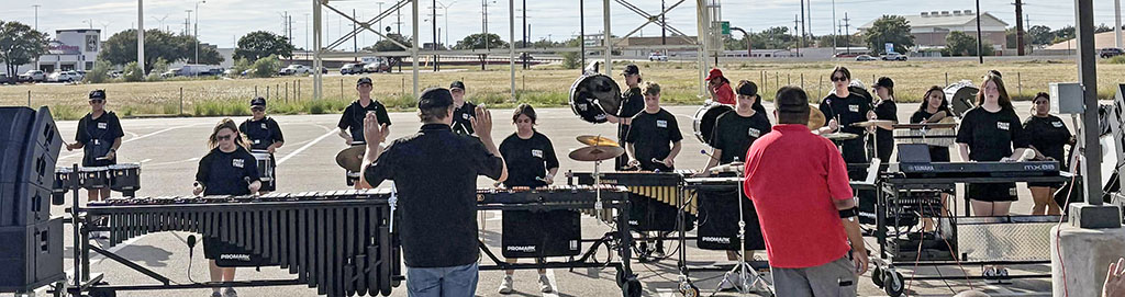 Drumline--
Band Assistant Director Logan Musel directs the drumline and front ensemble in competition at Monterey High School on Sept. 27. The group took fourth overall and the outstanding small school tenor line award.