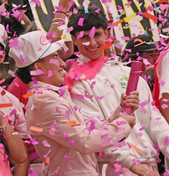 Confetti cloud--Juniors Omar Pinon and C.J. Mendoza join the pink flurry during the battle cry on October. 10.
