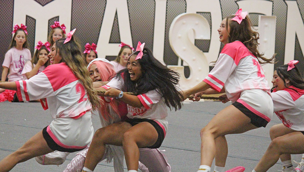 For dear life--Cheerleaders and volleyball players hang on during tug of war in the pep rally on Oct. 10.