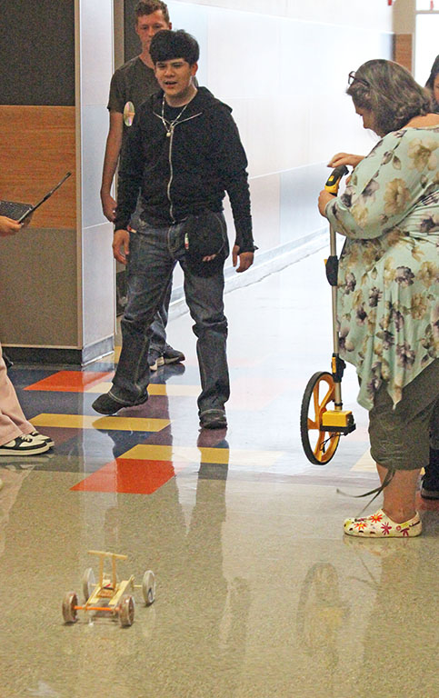 Please work--
Junior Jelena Hiebert and Esperanza Reyna test their mouse trap car in the classroom before the final run on Oct. 23. Groups worked on the project for three days before the trial run of their cars.