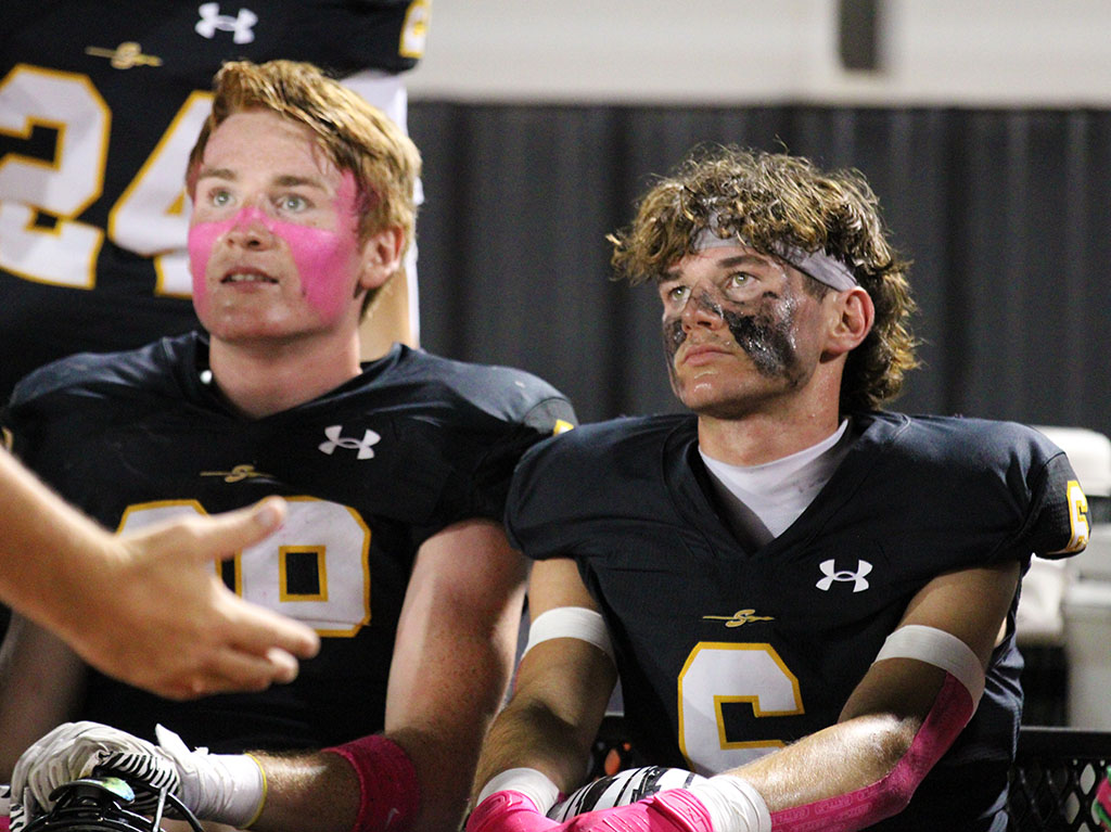 In the pink--Senior linebacker Ryan Werdenberg and junior cornerback Weston Dugan listen to Defensive Coordinator John Richmond during the Oct. 10 win over Fort Stockton.