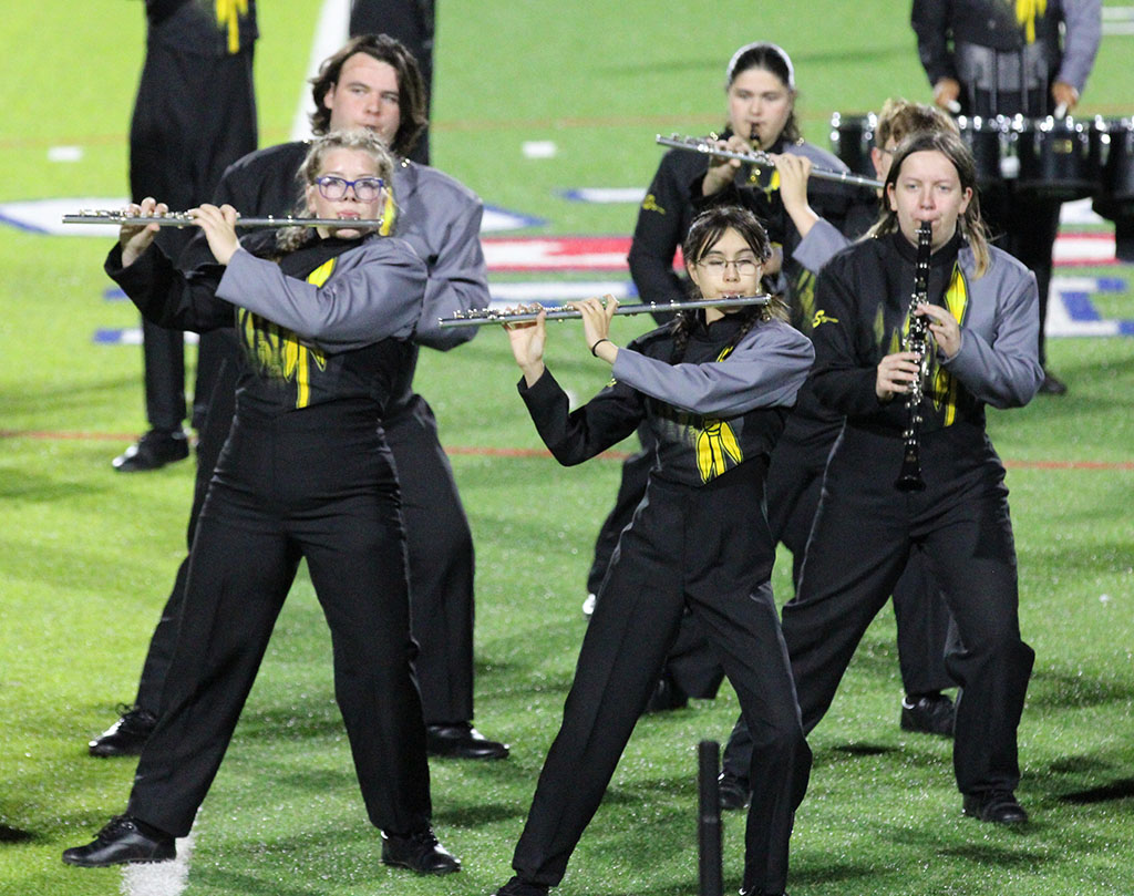 Lean into it--Woodwinds lean and play during the first movement of the Pride of the Tribe's show "The Heist" during region marching contest at Lowrey Field on Oct. 18.