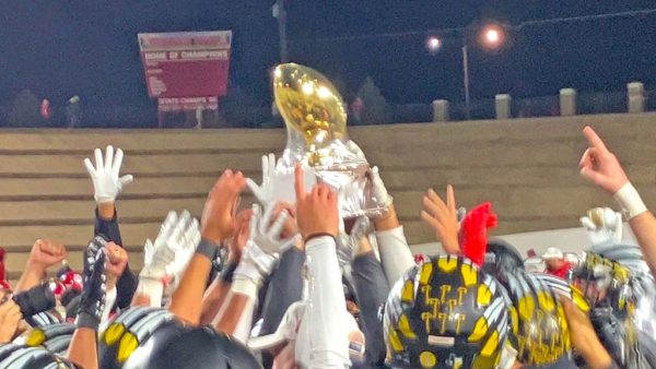 Not this time--Indians raise the area championship trophy after defeating Glen Rose, 39-27, in Sweetwater on Nov. 21. It was the third time the Indians had come up against the Tigers in three years in the playoffs.