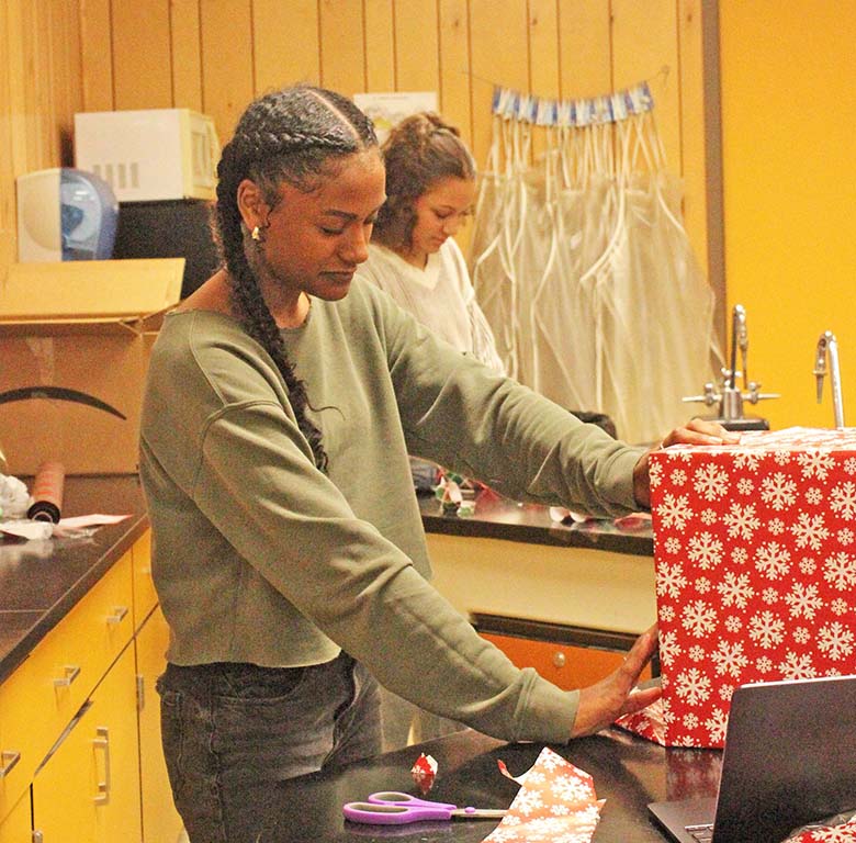 Wrap it up--
Sophomore Tabby Georges wraps a present for her honors chemistry door during second period on Dec. 4.