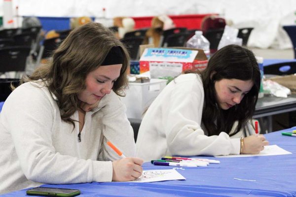 Colorful pastime--Junior Dallas Turner and Peyton Bailey color at the children's activity table at Snow Place Like Home on Nov. 18