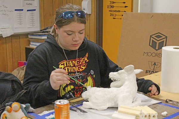 No ordinary deer--
Senior Amber Wallis dusts particles off her polymer clay baby deer during first period art class on Jan. 13. The sculpture would be baked and then painted.